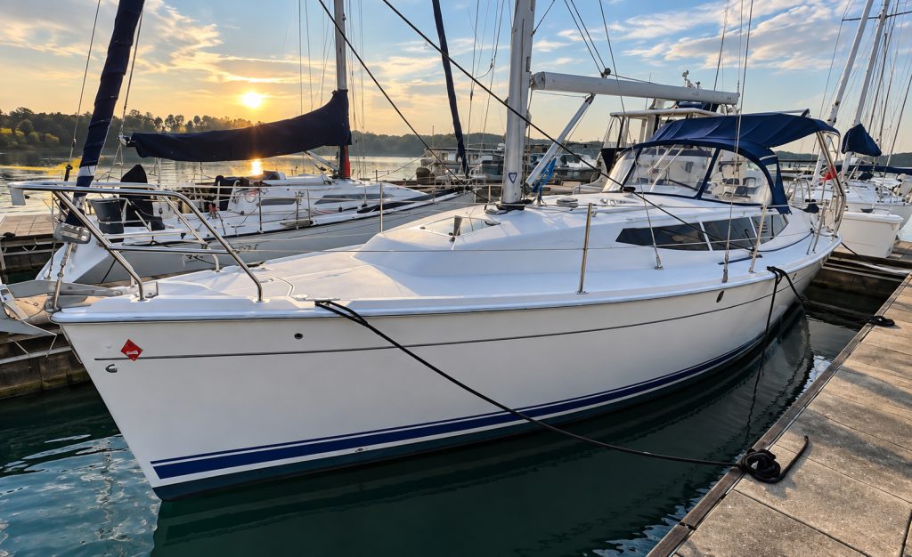 Sailboat moored at marina during golden hour